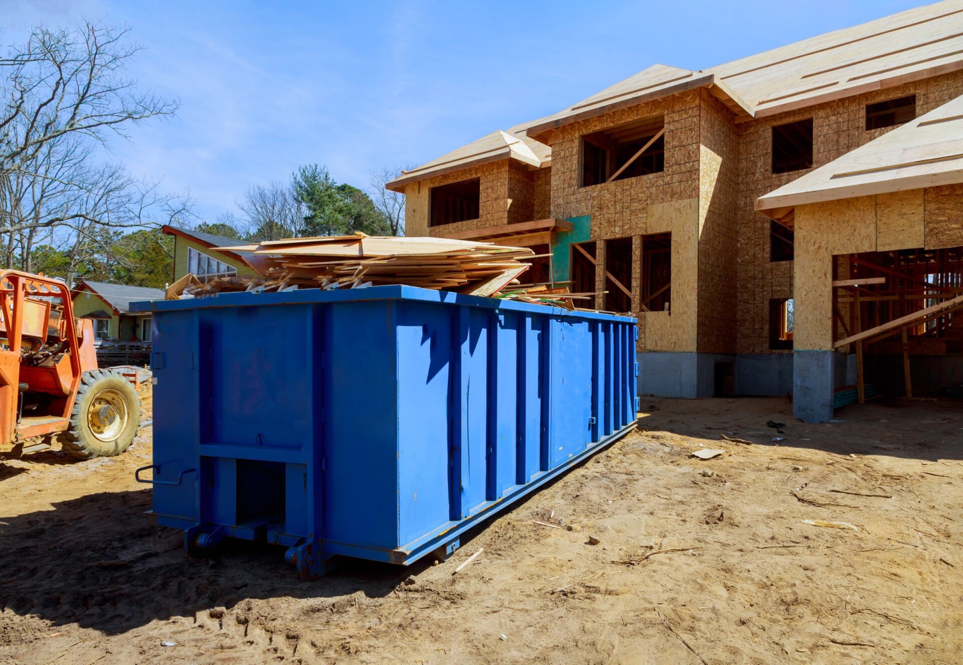 Construction trash dumpsters on metal container, house renovation.